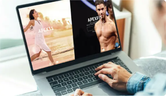 A Person Uses A Laptop Displaying Two Fitness Ads
